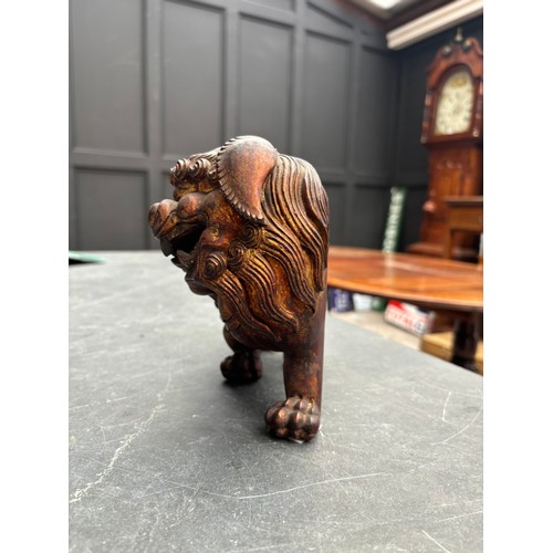 1523 - A Chinese carved giltwood lion dog, 23.5cm long; together with another Chinese carved giltwood figur... 