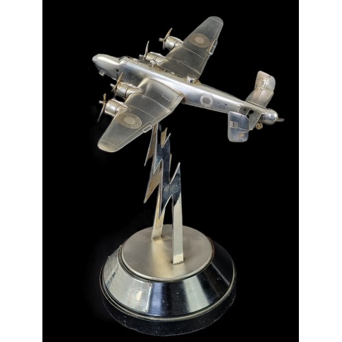 An historically important silver RAF Handley Page Halifax heavy bomber, by The Goldsmiths & Silversmiths Co Ltd, London 1945, on stylized lightning bolt support, with ebonised socle bearing silver plaque inscribed 'Air Marshal Sir C R Carr KBE, CB, CBE, DFC, AFC, by Sir Frederick Handley Page', overall height 31cm.