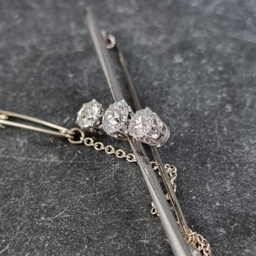 230 - A white metal diamond three stone bar brooch, set graduated brilliant cut stones, totalling approxim... 