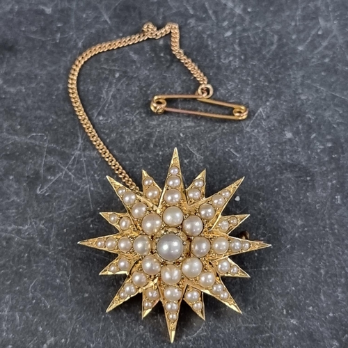 306 - A Victorian yellow metal starburst brooch, set split pearls, 34mm diameter.