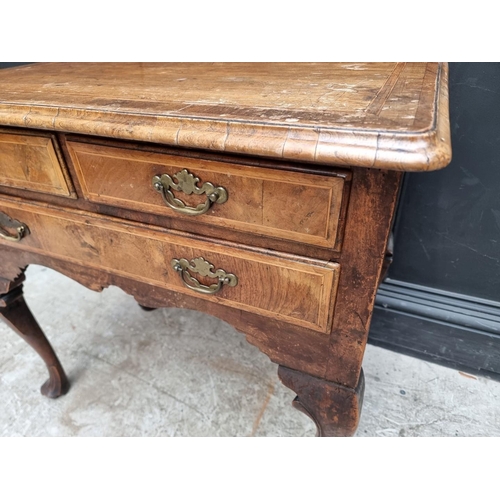 1002 - A George I/II walnut, line inlaid and crossbanded lowboy, 76cm wide.