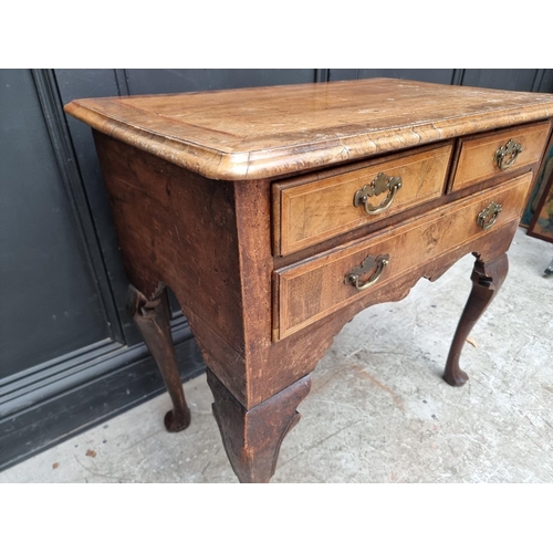 1002 - A George I/II walnut, line inlaid and crossbanded lowboy, 76cm wide.