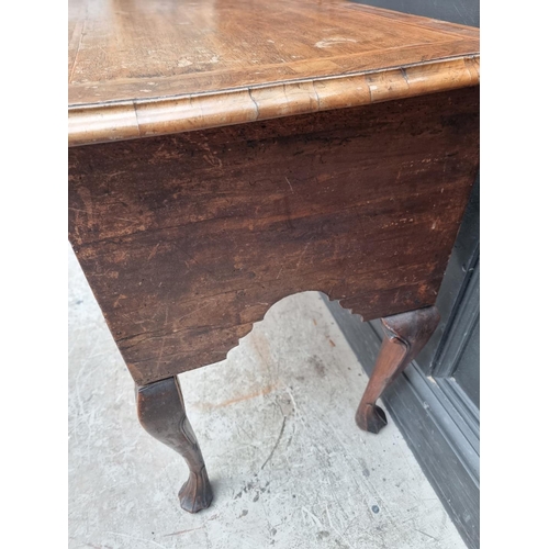 1002 - A George I/II walnut, line inlaid and crossbanded lowboy, 76cm wide.