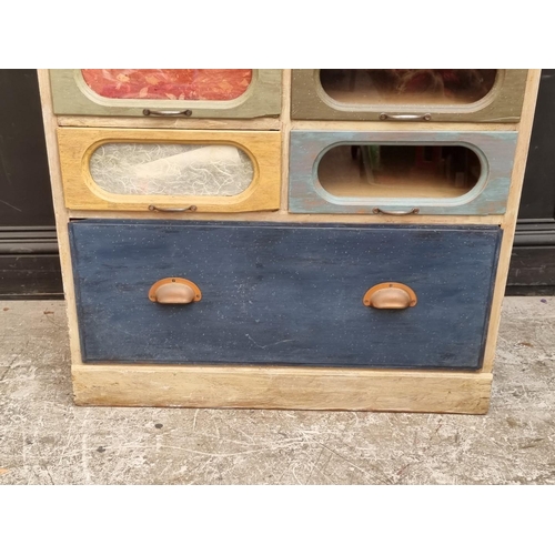 1004 - A vintage painted wood haberdasher's chest, 198cm high x 84cm wide.