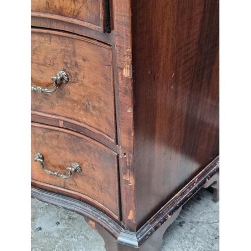 1008 - A 1930s burr walnut and crossbanded serpentine fronted chest of drawers, with brushing slide, 71cm w... 