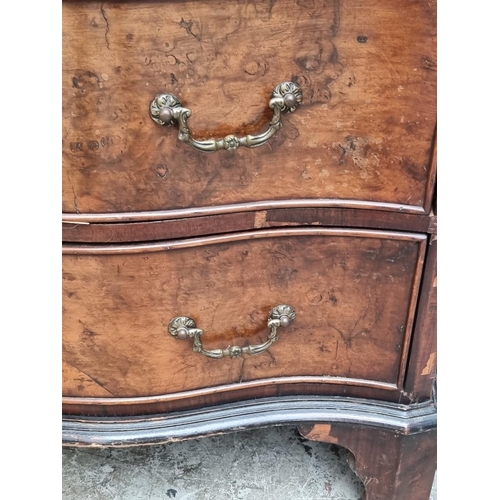 1008 - A 1930s burr walnut and crossbanded serpentine fronted chest of drawers, with brushing slide, 71cm w... 