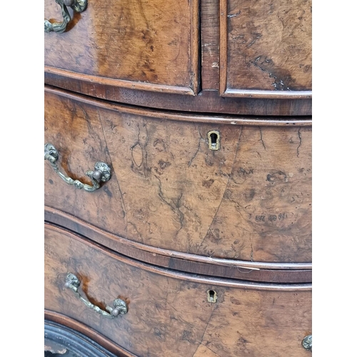 1008 - A 1930s burr walnut and crossbanded serpentine fronted chest of drawers, with brushing slide, 71cm w... 