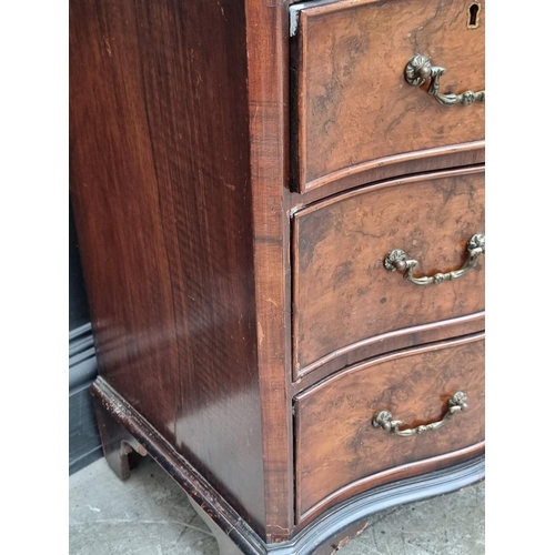 1008 - A 1930s burr walnut and crossbanded serpentine fronted chest of drawers, with brushing slide, 71cm w... 