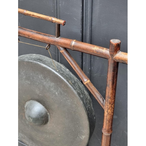 1009 - An old bamboo gong stand, total width 62.5cm, with beater.