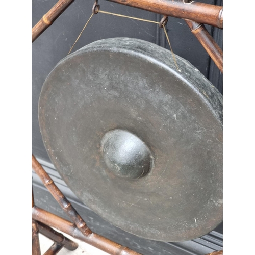 1009 - An old bamboo gong stand, total width 62.5cm, with beater.