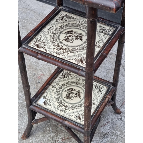 1011 - An Aesthetic bamboo three tier stand, inset with three Minton & Hollins & Co, 75cm high x 39... 