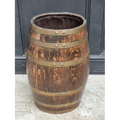 1019 - An old oak and coopered brass barrel, 61cm high.