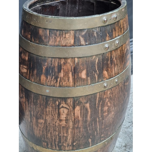 1019 - An old oak and coopered brass barrel, 61cm high.