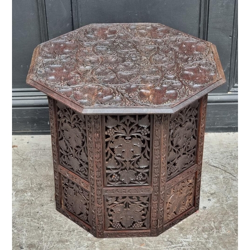 1028 - An Eastern carved and pierced hardwood octagonal folding table, 60cm wide.