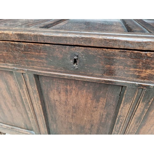 1037 - A late 17th century oak panelled coffer, 122.5cm wide.