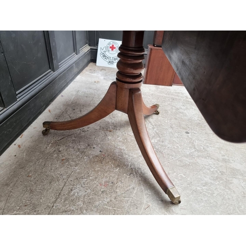 1057 - A 19th century mahogany tilt-top breakfast table, with drop leaf to one side, 122.5cm wide.... 