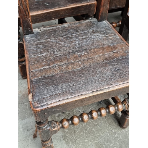 1063 - A set of six antique carved oak dining chairs, to include an elbow chair.