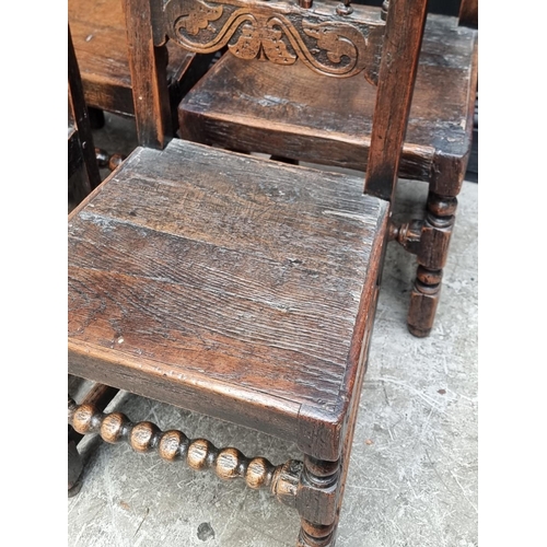 1063 - A set of six antique carved oak dining chairs, to include an elbow chair.