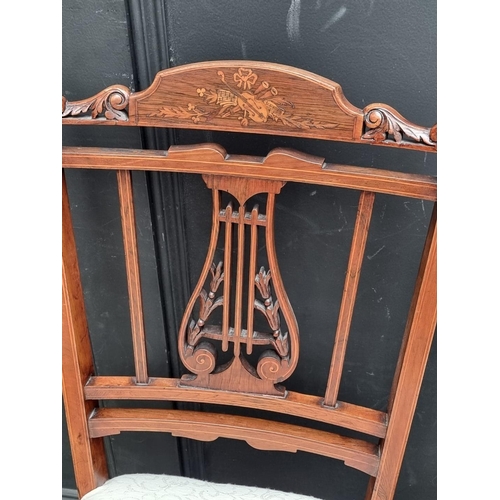 1068 - A pair of late 19th century rosewood and inlaid lyre back salon chairs.