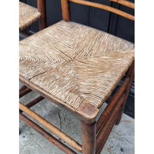 1072 - A pair of Victorian ash, beech and rush seated side chairs.