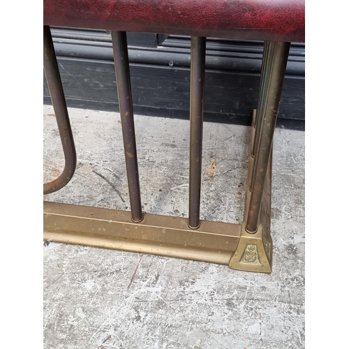 1080 - An old brass and buttoned leatherette adjustable club fender, 132-164cm wide.