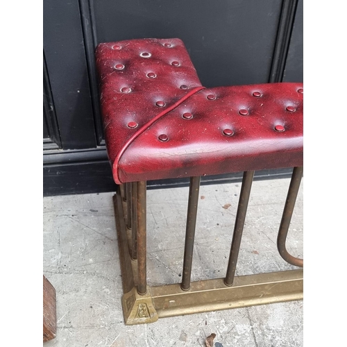 1080 - An old brass and buttoned leatherette adjustable club fender, 132-164cm wide.