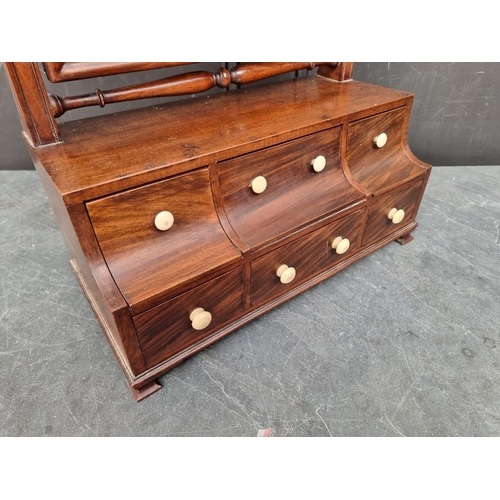 1093 - A Queen Anne style mahogany toilet mirror, with bone knobs, 80.5cm high.