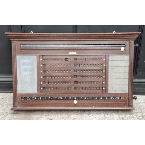 1095 - An early 20th century oak snooker score board, labelled 'Thurston & Co LD', with ivory markers, ... 