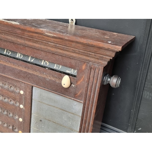 1095 - An early 20th century oak snooker score board, labelled 'Thurston & Co LD', with ivory markers, ... 