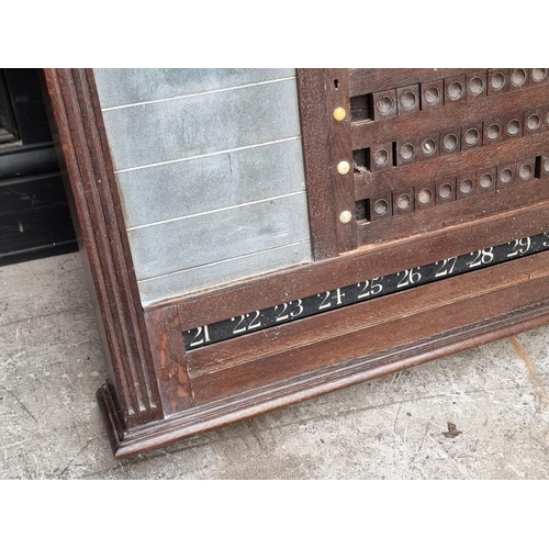 1095 - An early 20th century oak snooker score board, labelled 'Thurston & Co LD', with ivory markers, ... 