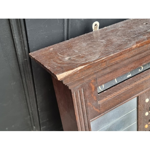 1095 - An early 20th century oak snooker score board, labelled 'Thurston & Co LD', with ivory markers, ... 