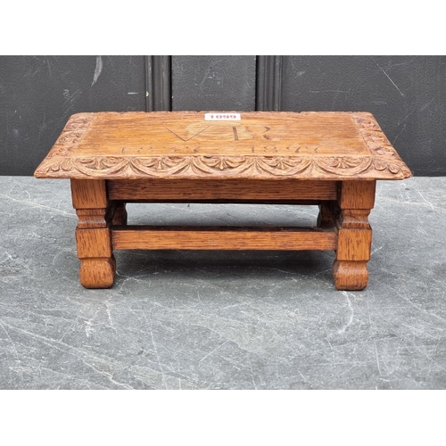 1099 - A Victorian carved oak 1897 Jubilee commemorative footstool, 28cm wide.