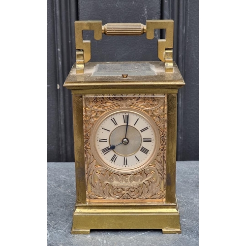 1116 - An old brass carriage clock, with silvered fretwork panels, striking on a gong, the movement signed ... 