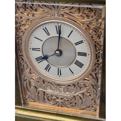 1116 - An old brass carriage clock, with silvered fretwork panels, striking on a gong, the movement signed ... 