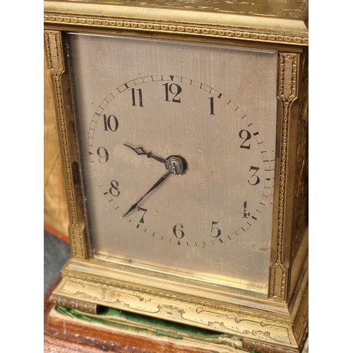 1118 - An unusual engraved brass carriage clock, with silvered dial, gong strike and push button repeat, he... 