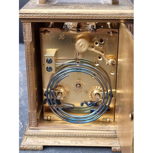 1118 - An unusual engraved brass carriage clock, with silvered dial, gong strike and push button repeat, he... 