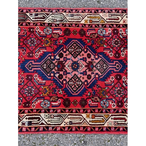 1131 - A Persian runner, having central diamond medallion, with geometric borders, 198 x 80cm.... 