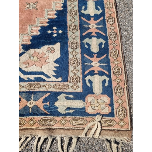 1134 - A Persian rug, having central diamond medallion, with floral cartouches to each corner, 308 x 202cm.... 