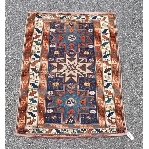 1136 - A small Persian rug, having three central medallions, with geometric borders, 142 x 92cm.... 