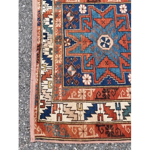 1136 - A small Persian rug, having three central medallions, with geometric borders, 142 x 92cm.... 