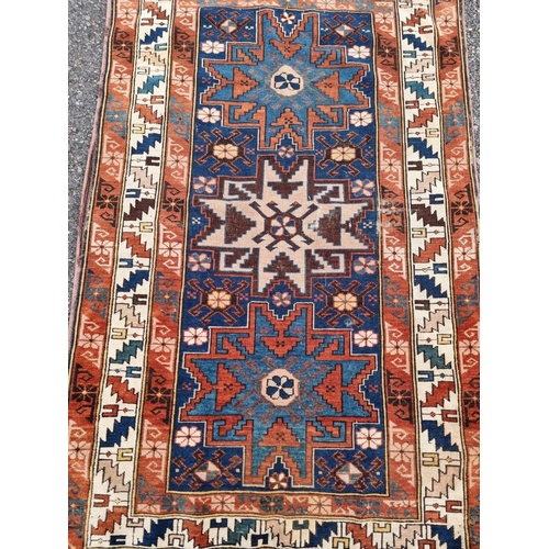 1136 - A small Persian rug, having three central medallions, with geometric borders, 142 x 92cm.... 