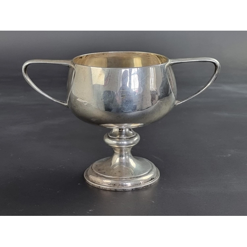 10 - An Indian white metal twin handled pedestal cup, stamped 'Silver', 12.5cm high.