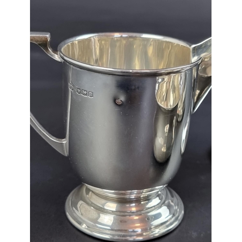 124 - A silver milk jug, probably by William Bush & Son Ltd, Sheffield 1944, height to handle 9cm... 