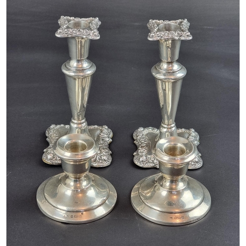 125 - A pair of silver candlesticks, by Walker & Hall, Birmingham 1911, 15cm high; together with anoth... 