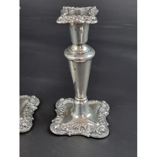 125 - A pair of silver candlesticks, by Walker & Hall, Birmingham 1911, 15cm high; together with anoth... 