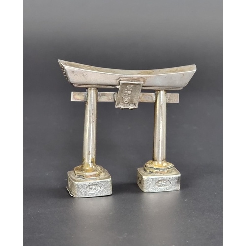 152 - A Japanese white metal novelty Torii gate pepperette, stamped 'Sterling', 6cm high.