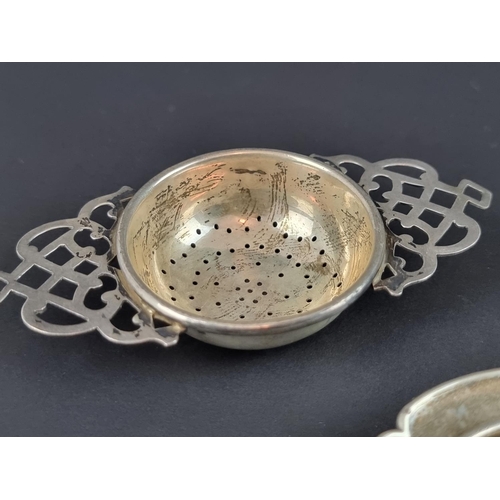 171 - A silver tea strainer, by Robert Pringle & Sons, London 1924, 10.5cm wide; together with tw... 