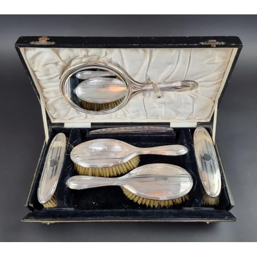 192 - A cased engine turned silver five piece dressing table set, by Samuel M Levi, Birmingham 1924/5, wit... 