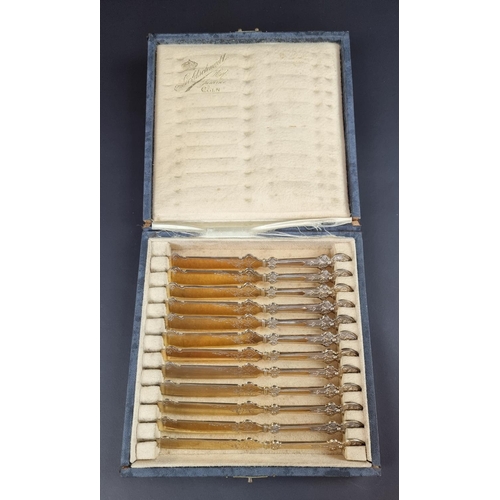 199 - A cased set of twelve German gilded white metal knives, by Goldschmidt of Coln, stamped '800'.... 