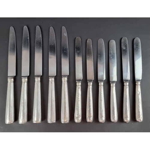 210 - A set of five silver handled knives, marks rubbed; together with six other silver handled knives, in... 